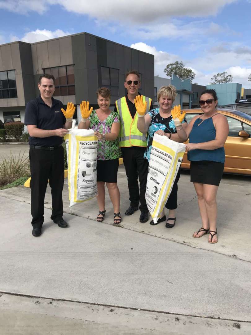 AOL staff clean up the streets - Australian Outdoor Living CEO Chris Taylor (centre) with staff from the company's QLD branch, Australian Outdoor Living.