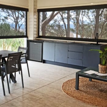 Custom Outdoor Kitchen With Charcoal Cabinetry, Sleek Tapware and Flat Cooktop