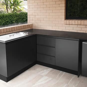 Black Outdoor Kitchen in a corner with Flat Stainless Steel Cooktop