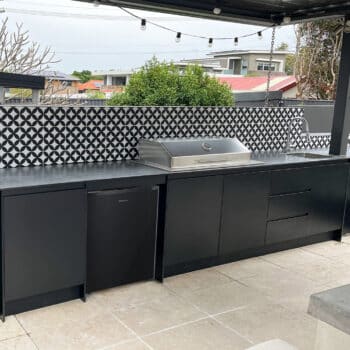 Customised Outdoor Kitchen With Hooded Cooktop and Sleek Sink and Tapware